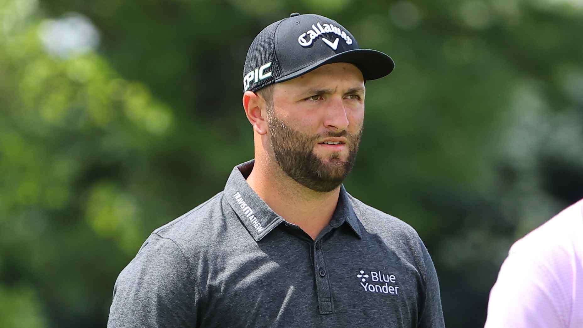 Jon Rahm looks down the fairway during a golf tournament