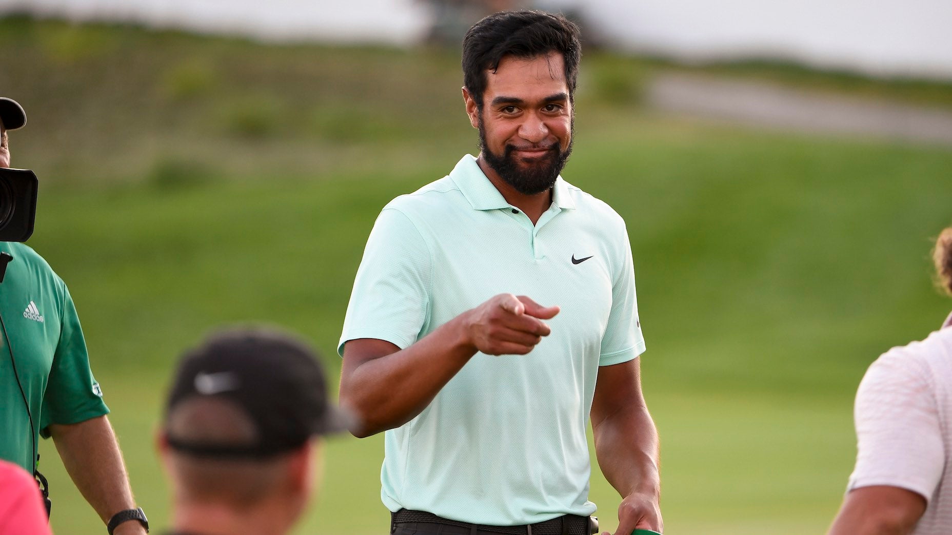 Tony Finau sharing in the celebration with his coach Boyd Summerhays.