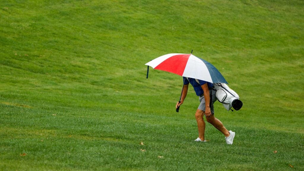 player hides under umbrella