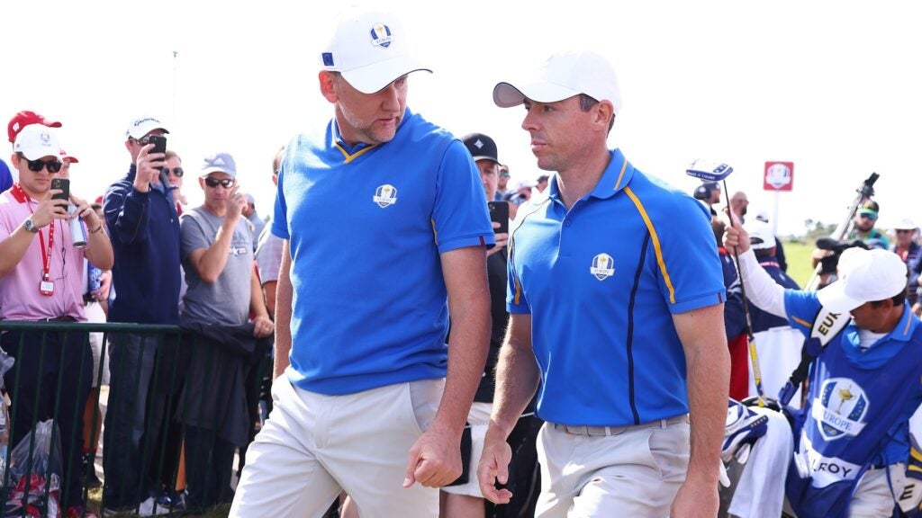 KOHLER, WISCONSIN - SEPTEMBER 24: Ian Poulter of England and team Europe (L) and Rory McIlroy of Northern Ireland and team Europe walk across the course during Friday Morning Foursome Matches of the 43rd Ryder Cup at Whistling Straits on September 24, 2021 in Kohler, Wisconsin. (Photo by Warren Little/Getty Images)