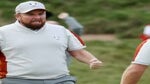 Shane Lowry grimaces in celebration facing partner Tyrrell Hatton at the 2021 Ryder Cup.