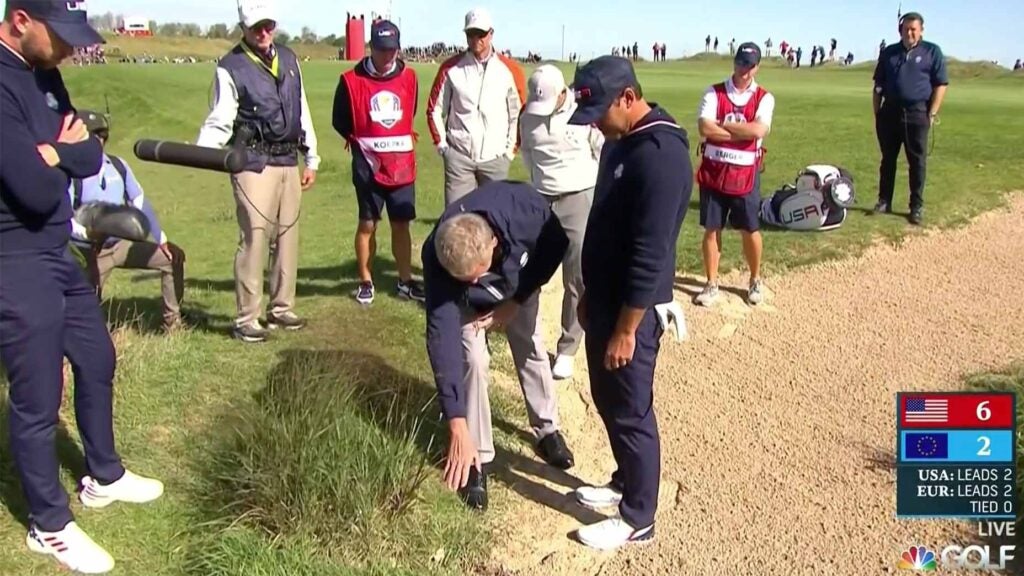 brooks koepka talks to a rules official at the ryder cup