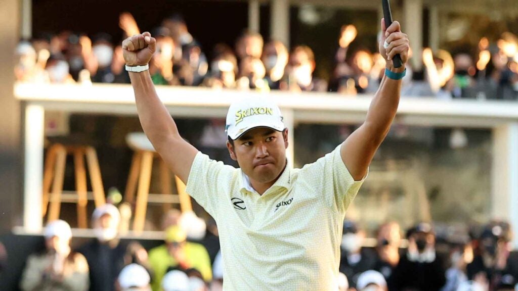 Hideki Matsuyama raises his arms in victory