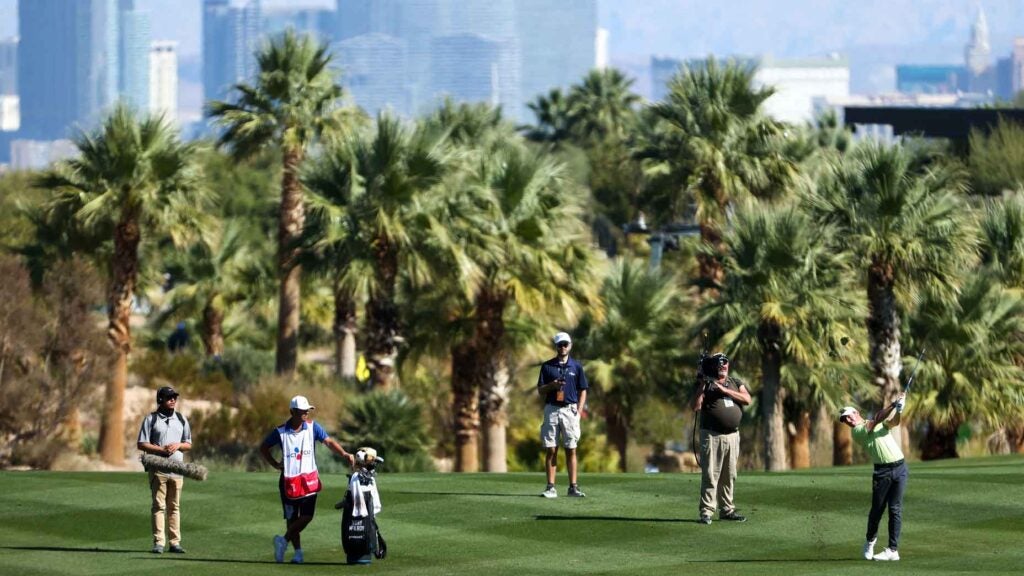 Rory McIlroy hits a shot against the Las Vegas skyline