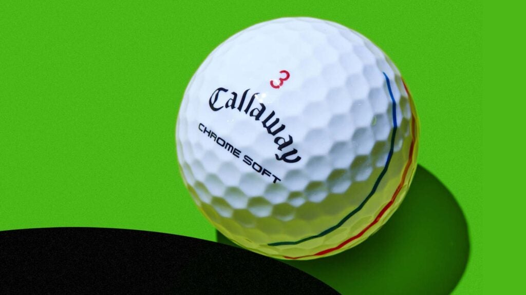 A Callaway Chrome Soft Triple Track golf ball against a green background