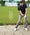 A man hits out of a fairway bunker