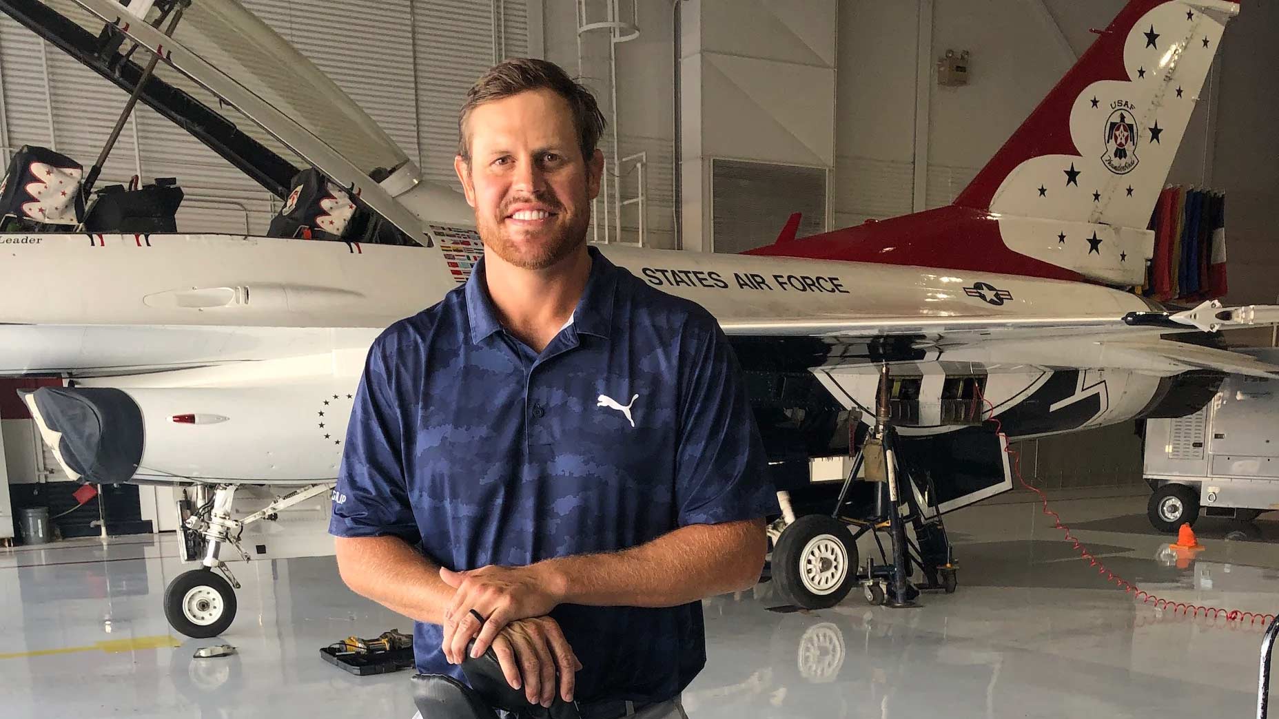 Kyle Westmoreland poses in front of a Thunderbirds fighter jet