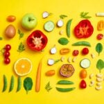 Fruits and vegetables laid on a yellow background