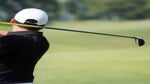 a golfer swings