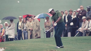 Lee Elder watches his chip shot in front of a small gallery during the 1975 Masters Tournament at Augusta National Golf Club on April 1975 in Augusta, Georgia
