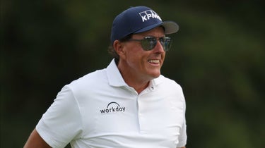 Phil Mickelson looks on from the 18th green during the first round of the Dominion Energy Charity Classic on October 22, 2021, at The Country Club of Virginia James River Course in Richmond, VA.