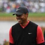 tiger woods smiles during golf tournament