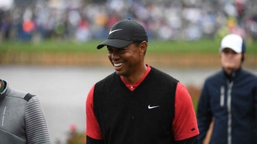 tiger woods smiles during golf tournament
