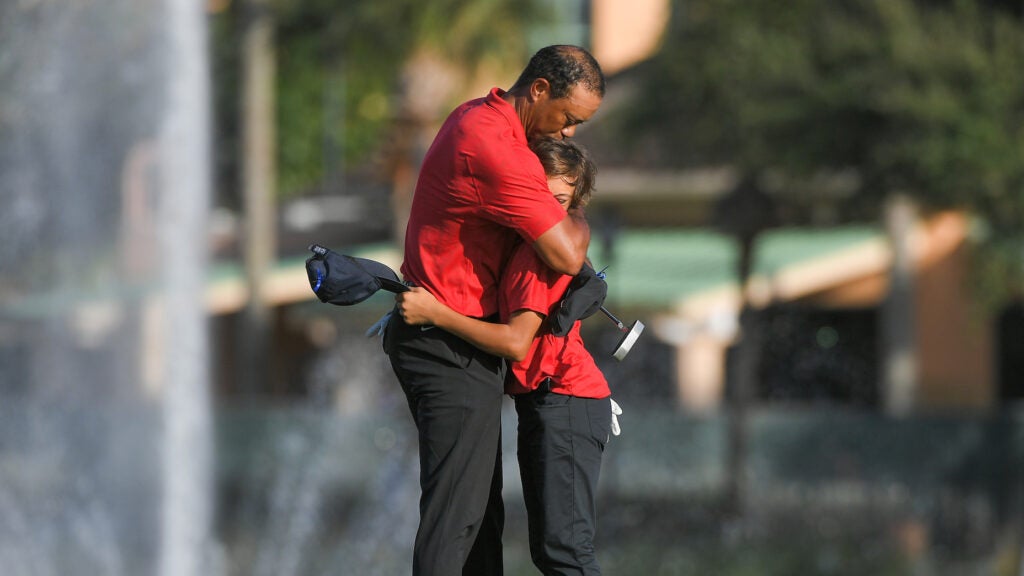 Tiger Woods and his 12-year-old son, Charlie, embracing on the 18th green.