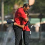 Tiger Woods and his 12-year-old son, Charlie, embracing on the 18th green.