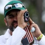 Caddie Michael Greller uses his rangefinder at Augusta National?