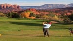 A man tees off on a golf course