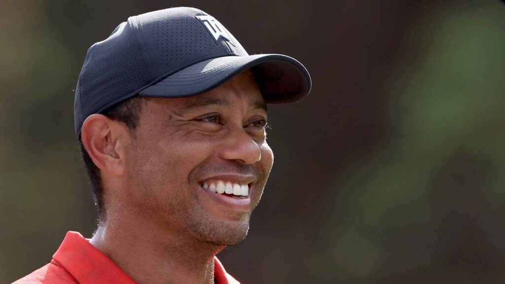 tiger woods looks into the distance.