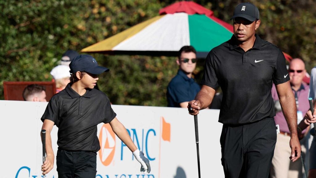 Tiger Woods and Charlie Woods walk off tee during 2021 PNC Championship Pro-Am