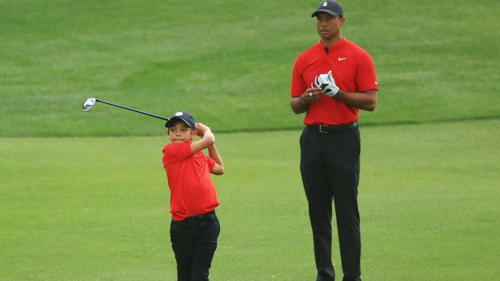 Tiger Woods watches Charlie Woods hit golf shot during 2020 PNC Championship