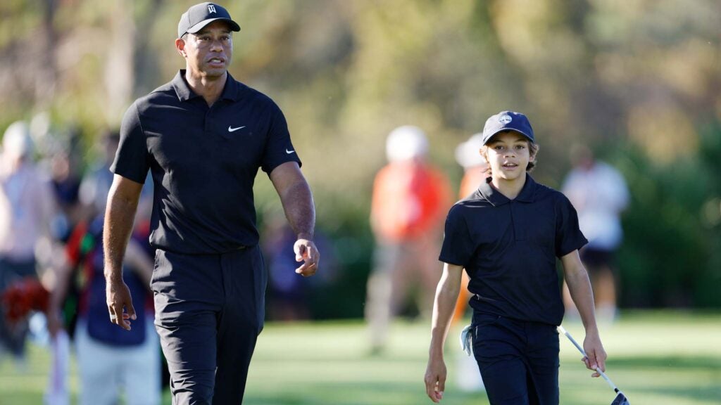 Tiger Woods and Charlie Woods walk together before the 2021 PNC Championship Pro-Am