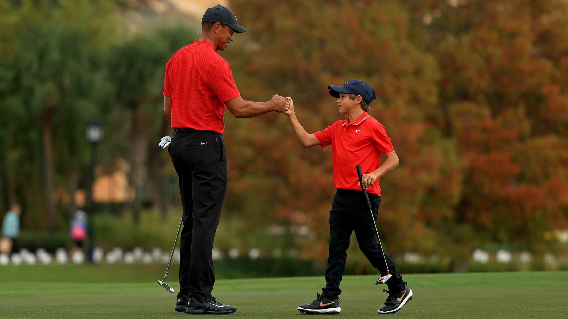 Tiger Woods and Charlie Woods bump fists at the 2021 PNC Championship