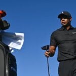 Tiger Woods walks near his / her golf bag during 2021 PNC Championship Pro-Am