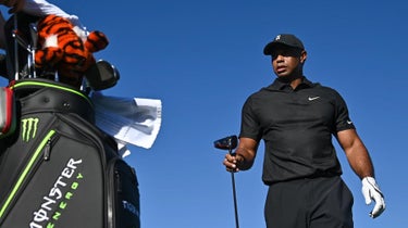 Tiger Woods walks near his golf bag during 2021 PNC Championship Pro-Am