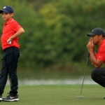 Tiger Woods of the United States and son Charlie Woods line up a putt on the 15th hole during the final round of the PNC Championship at the Ritz Carlton Golf Club on December 20, 2020 in Orlando, Florida.