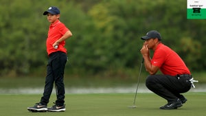 Tiger Woods of the United States and son Charlie Woods line up a putt on the 15th hole during the final round of the PNC Championship at the Ritz Carlton Golf Club on December 20, 2020 in Orlando, Florida.