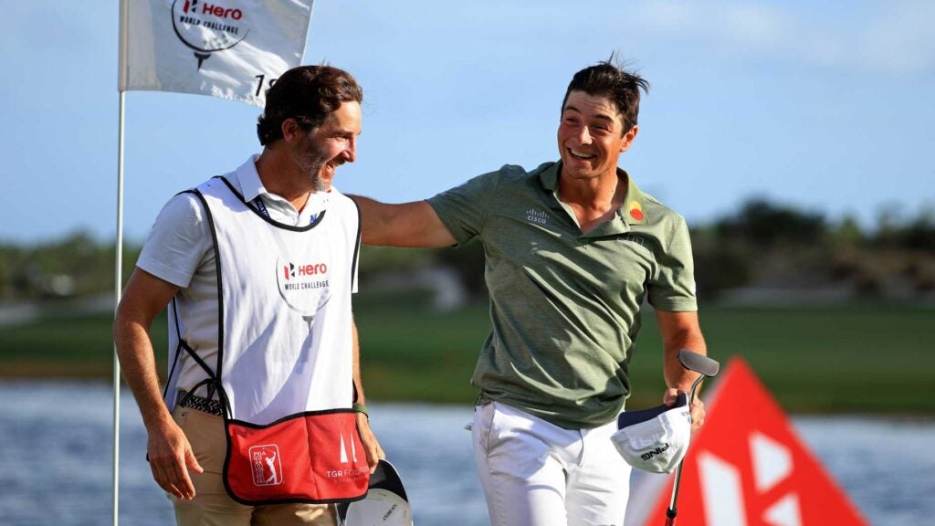 Viktor Hovland congratulates his caddie on green after Hero World Challenge win