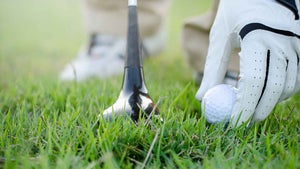 golfer placing ball
