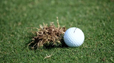 golf ball next to divot