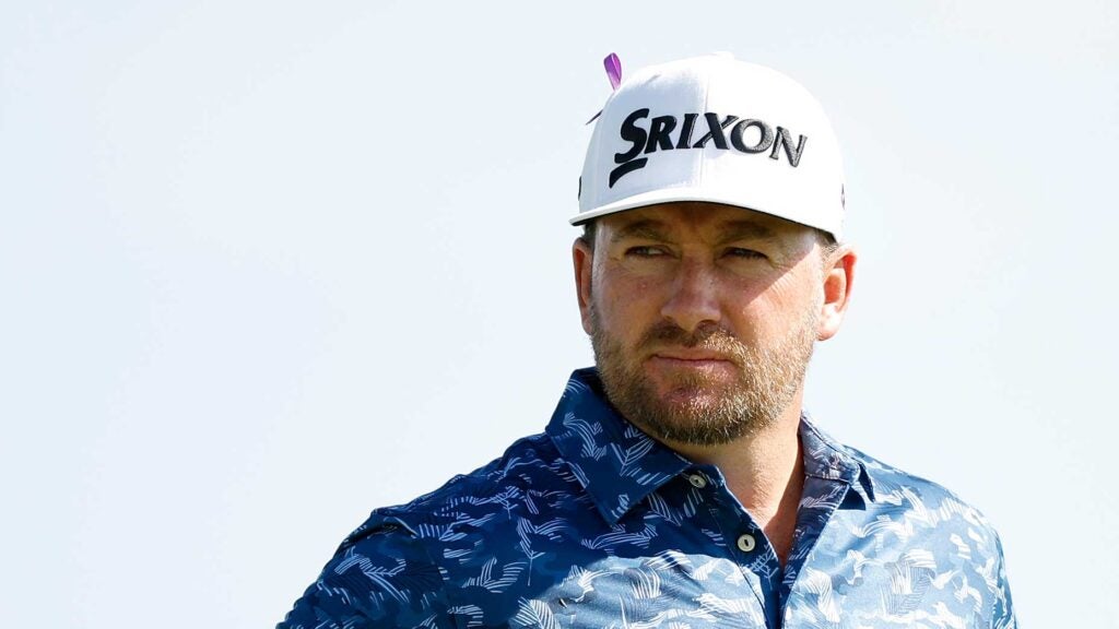 Graeme McDowell, wearing a purple ribbon, looks on during the first round of the Sony Open.