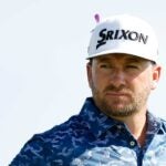 Graeme McDowell, wearing a purple ribbon, looks on during the first round of the Sony Open.