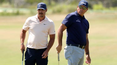 brooks koepka stands with phil mickelson