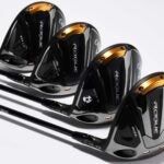 Four Callaway Rogue ST Max drivers laying on grey background