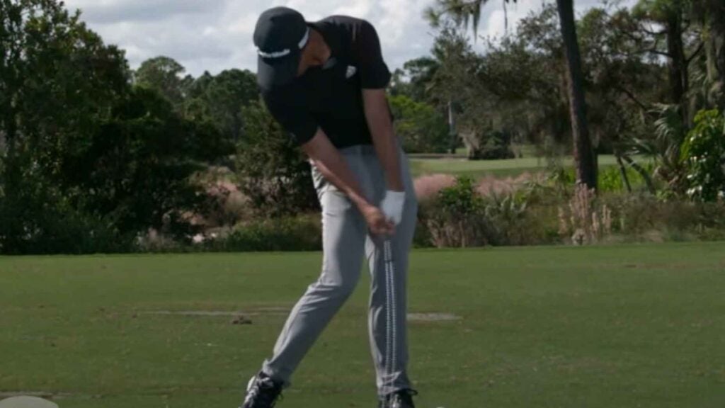 collin morikawa swings a golf club