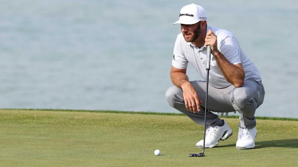 Dustin Johnson reads a putt during the first round of the Saudi International.