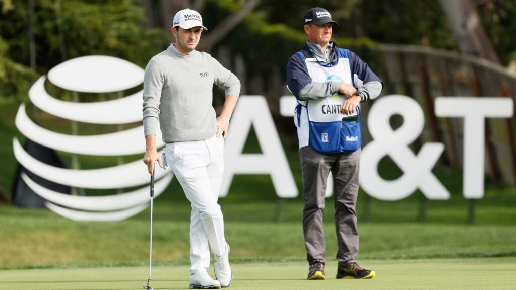 Patrick Cantlay stands on green with caddie during 2021 AT&T Pebble Beach Pro-Am