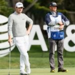 Patrick Cantlay stands on green with caddie during 2021 AT&T Pebble Beach Pro-Am