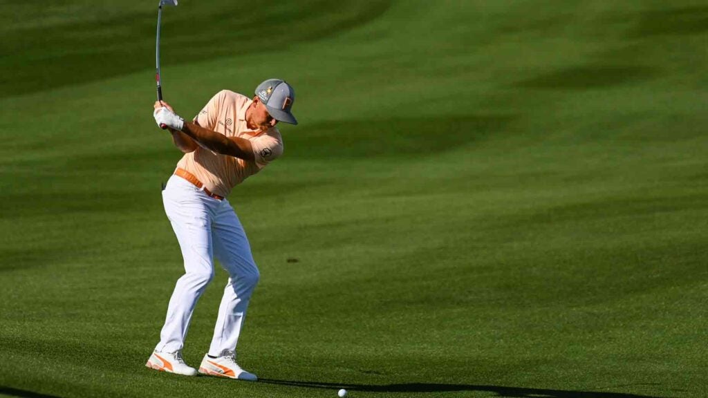 rickie fowler hits ball of downhill lie
