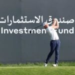 player hits in front of saudi investment fund sign