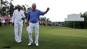 Ben Crenshaw waves to the gallery alongside caddie Carl Jackson after playing his final Masters in 2015.