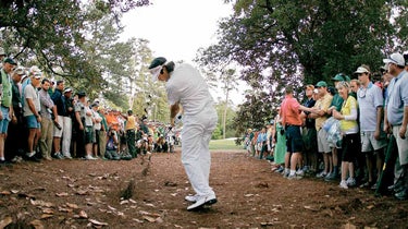 Bubba Watson hits a shot out of the pine straw at the 2012 Masters.