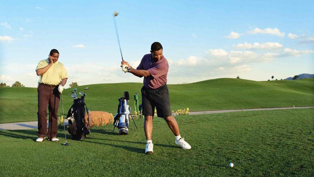 two golfers on tee