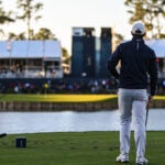 Pro golfer stands on 17th green at TPC Sawgrass