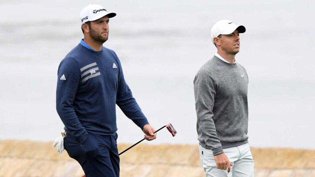 Jon Rahm and Rory McIlroy walk up the 18th hole during the 2019 U.S. Open at Pebble Beach.