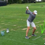 PGA Tour pros practice with alignment sticks on driving range at Arnold Palmer Invitational