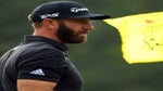 Dustin Johnson looks into distance next to Masters pin flag at 2022 Masters